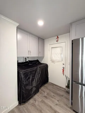 a kitchen with a refrigerator and a stove top oven