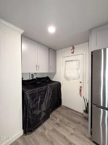 a kitchen with a refrigerator and a stove top oven