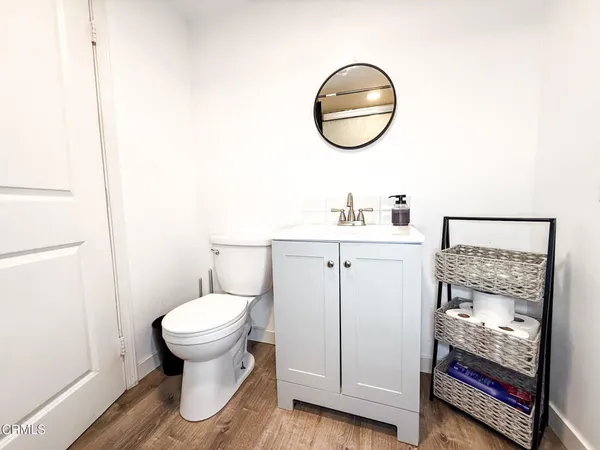 a bathroom with a toilet a sink and a mirror