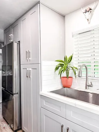 a close view of sink and refrigerator