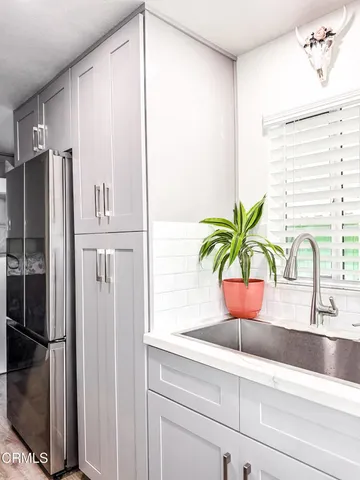 a close view of sink and refrigerator