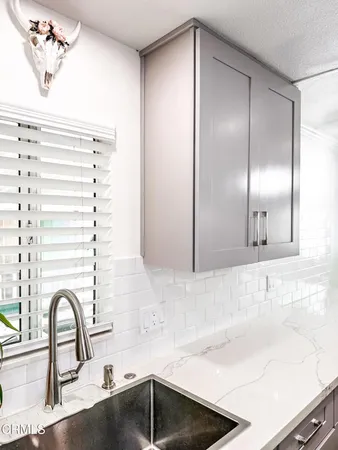 a bathroom with a sink and a large mirror