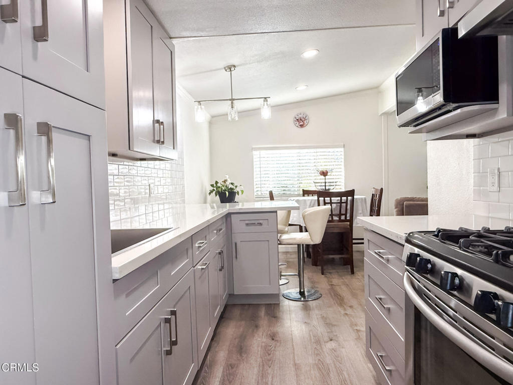4108 Ranchita Lane Oxnard, CA 93033 - Photo 8 of 19 a kitchen with white cabinets and appliances