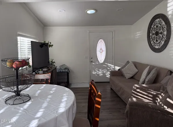 a living room with couches chairs and a large mirror