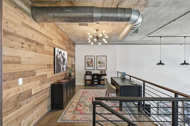 a view of a dining room with furniture a chandelier and wooden floor
