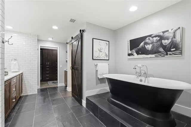 a living room with stainless steel appliances kitchen island granite countertop furniture a sink and a refrigerator