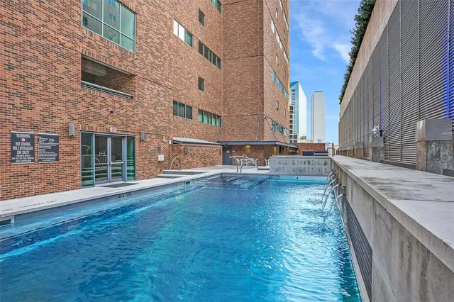 a view of backyard with outdoor seating and barbeque oven