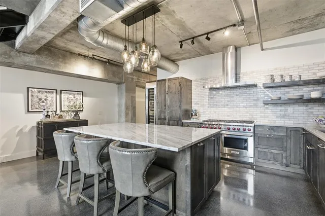 a kitchen with a table chairs and white cabinets