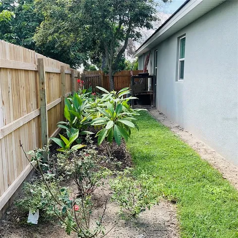 a backyard of a house with table and chairs