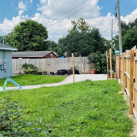a view of a house with backyard sitting area and garden