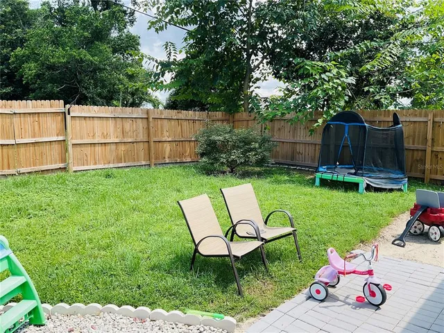 a bedroom with a bed and a potted plant