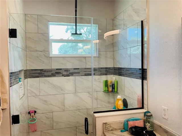 a kitchen with stainless steel appliances a stove refrigerator sink and microwave