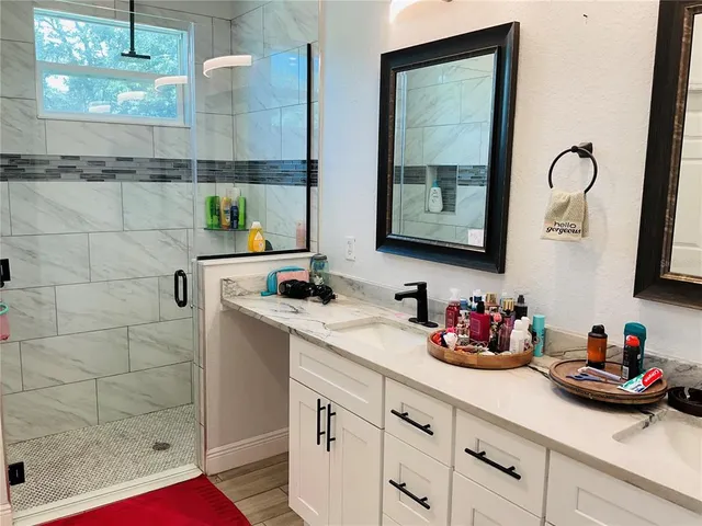 a kitchen with granite countertop a stove a sink a dining table and chairs