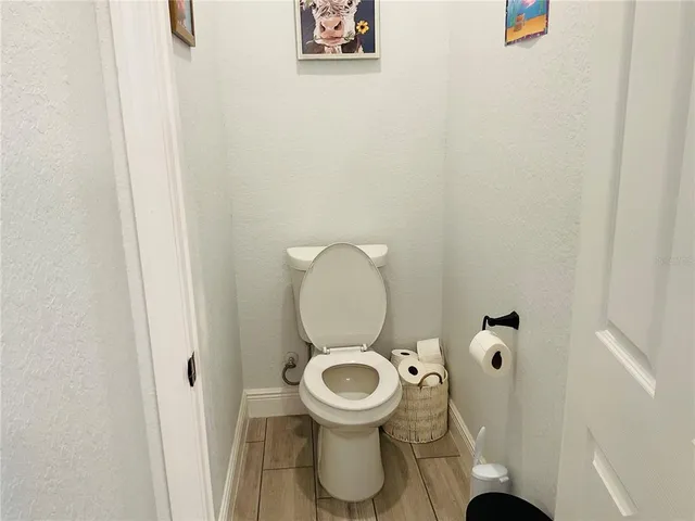 a kitchen with stainless steel appliances granite countertop a table chairs sink refrigerator and microwave