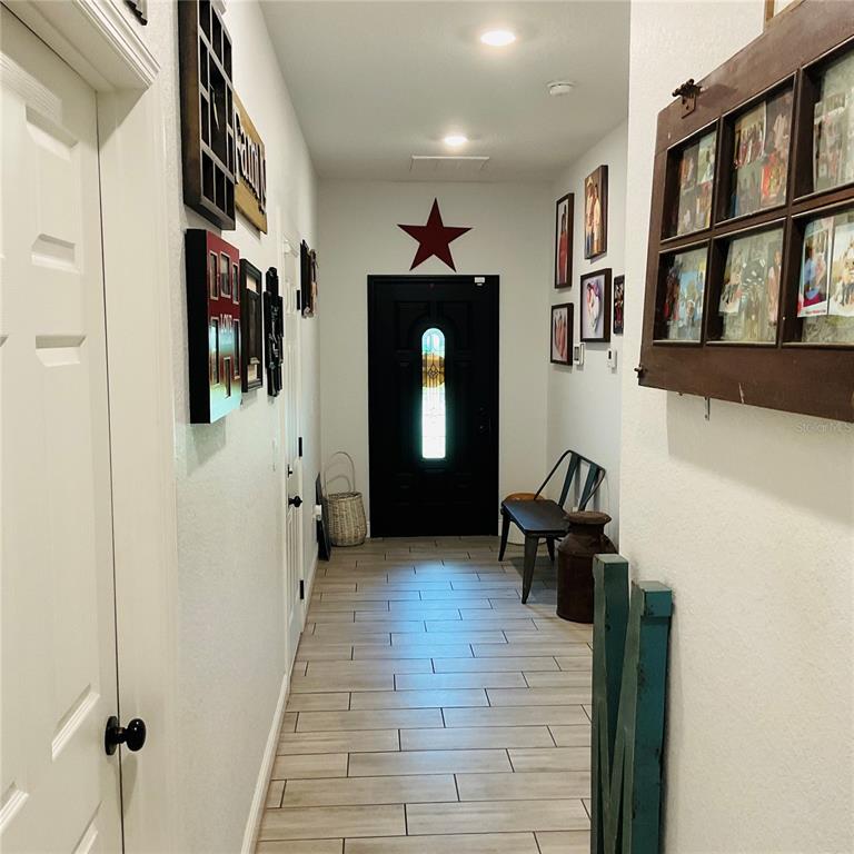 515 5th Street South Dundee, FL 33838 - Photo 4 of 74 a hallway with front door wooden floor and furniture