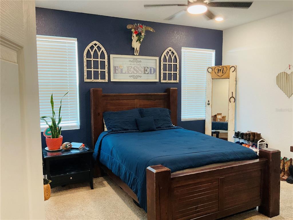 515 5th Street South Dundee, FL 33838 - Photo 43 of 74 a bedroom with a bed and a potted plant