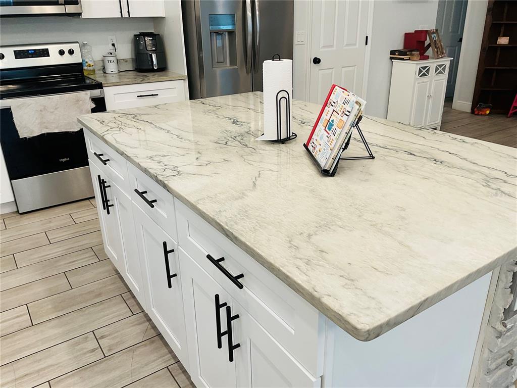 515 5th Street South Dundee, FL 33838 - Photo 50 of 74 a kitchen with kitchen island sink stove and refrigerator