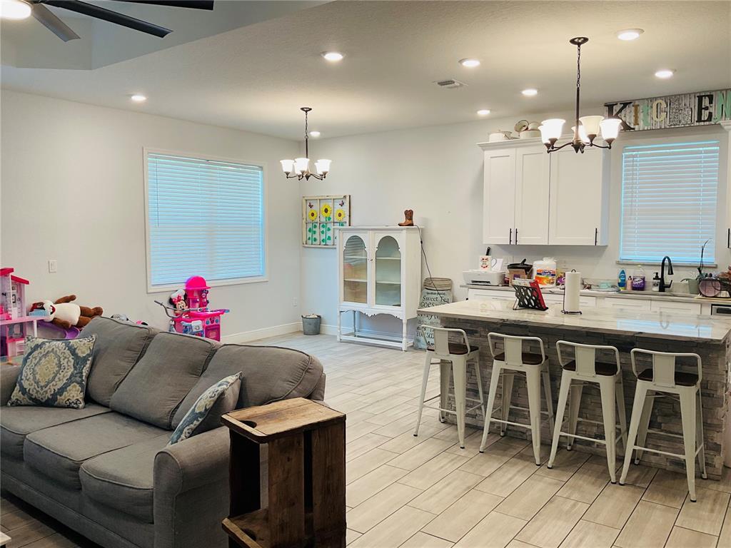 515 5th Street South Dundee, FL 33838 - Photo 61 of 74 a living room with furniture a dining table and a chandelier