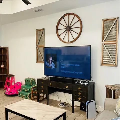 a living room with stainless steel appliances kitchen island granite countertop a couch and a view of kitchen
