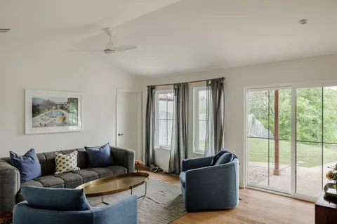a living room with furniture and large windows