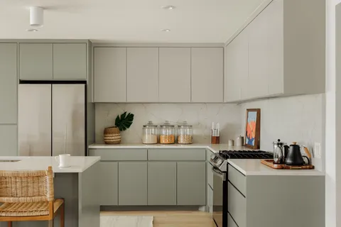 a room with a sink a stove and a refrigerator