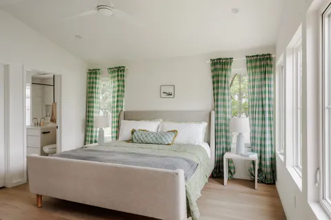 a bedroom with a large bed and a window