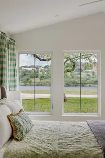 a living room with a large window and a bed