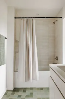 a bathroom with a shower curtain and a sink