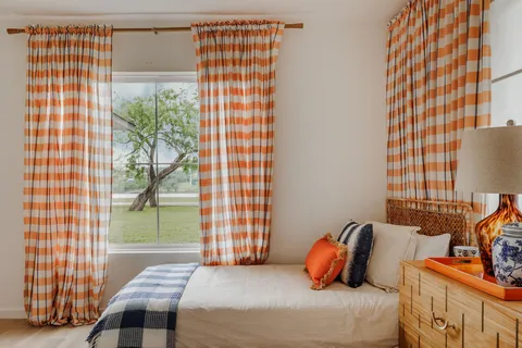 a bedroom with a bed and window
