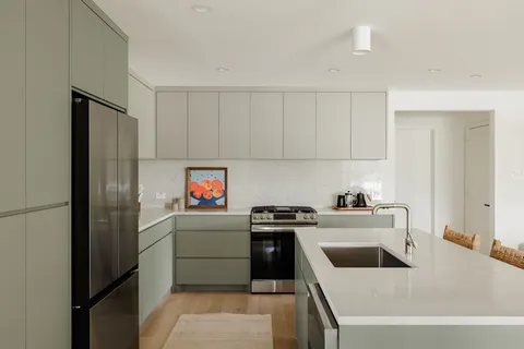a kitchen with a stove a refrigerator and a sink