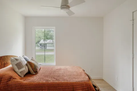 a bedroom with a bed and window