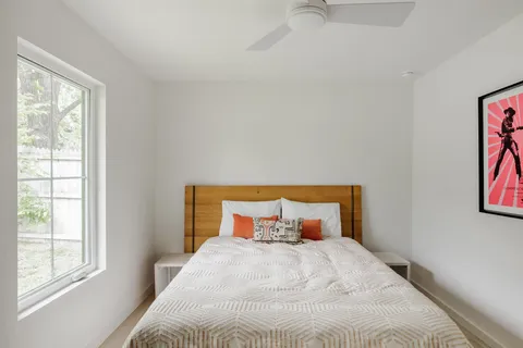 a bedroom with a bed and window