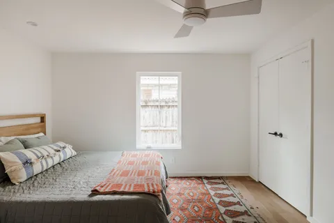 a bedroom with a bed and a window