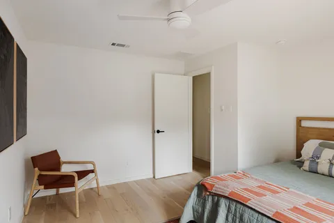 a bedroom with a bed and a chair
