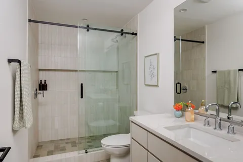a bathroom with a sink toilet and shower