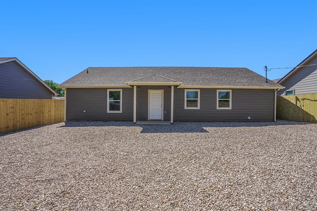405 North Cleburne Whitney Road Rio Vista, TX 76093 - Photo 22 of 23 Single-story exterior with horizontal siding, a light gray roof, and a gravel yard