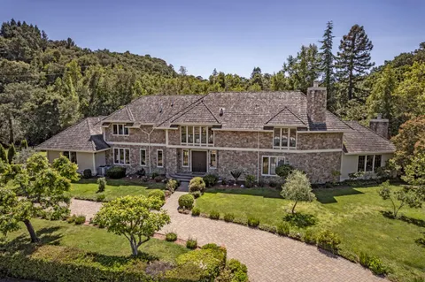 a aerial view of a house next to a yard
