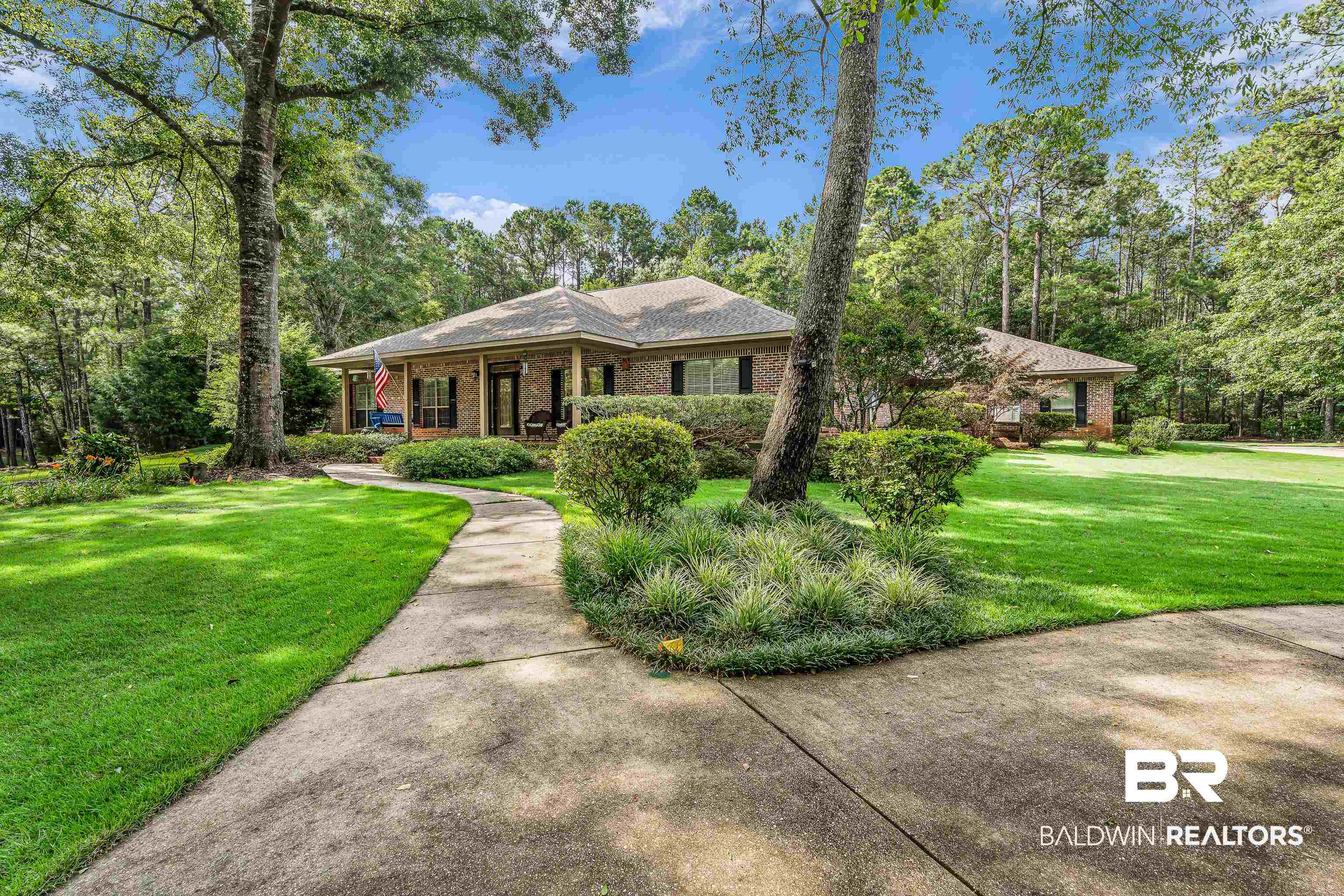 7014 Blakeley Road Daphne, AL 36527 - Photo 5 of 45 Brick exterior residential structure with a covered front porch and a gabled roof