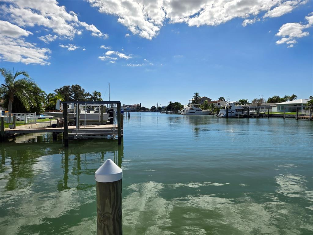 530 Lillian Drive Madeira Beach, FL 33708 - Photo 11 of 56 a view of a lake with boats and trees in the background