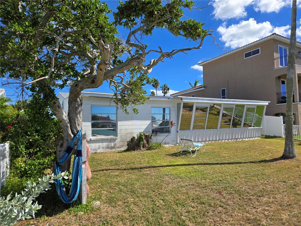 530 Lillian Drive Madeira Beach, FL 33708 - Photo 13 of 56 a front view of a house with a garden