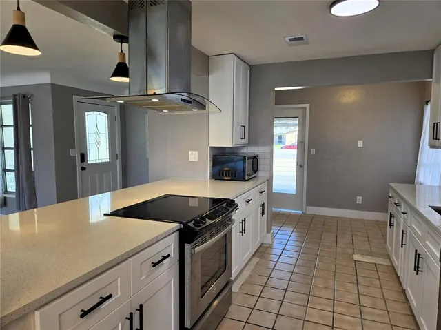 a kitchen with a sink stove and cabinets