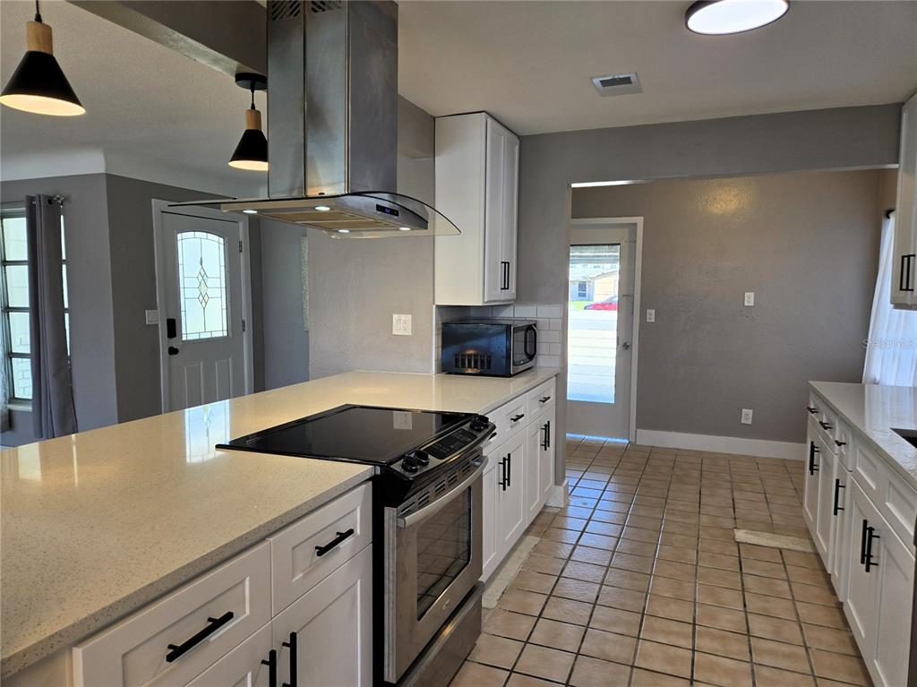 530 Lillian Drive Madeira Beach, FL 33708 - Photo 22 of 56 a kitchen with stainless steel appliances granite countertop a sink and cabinets
