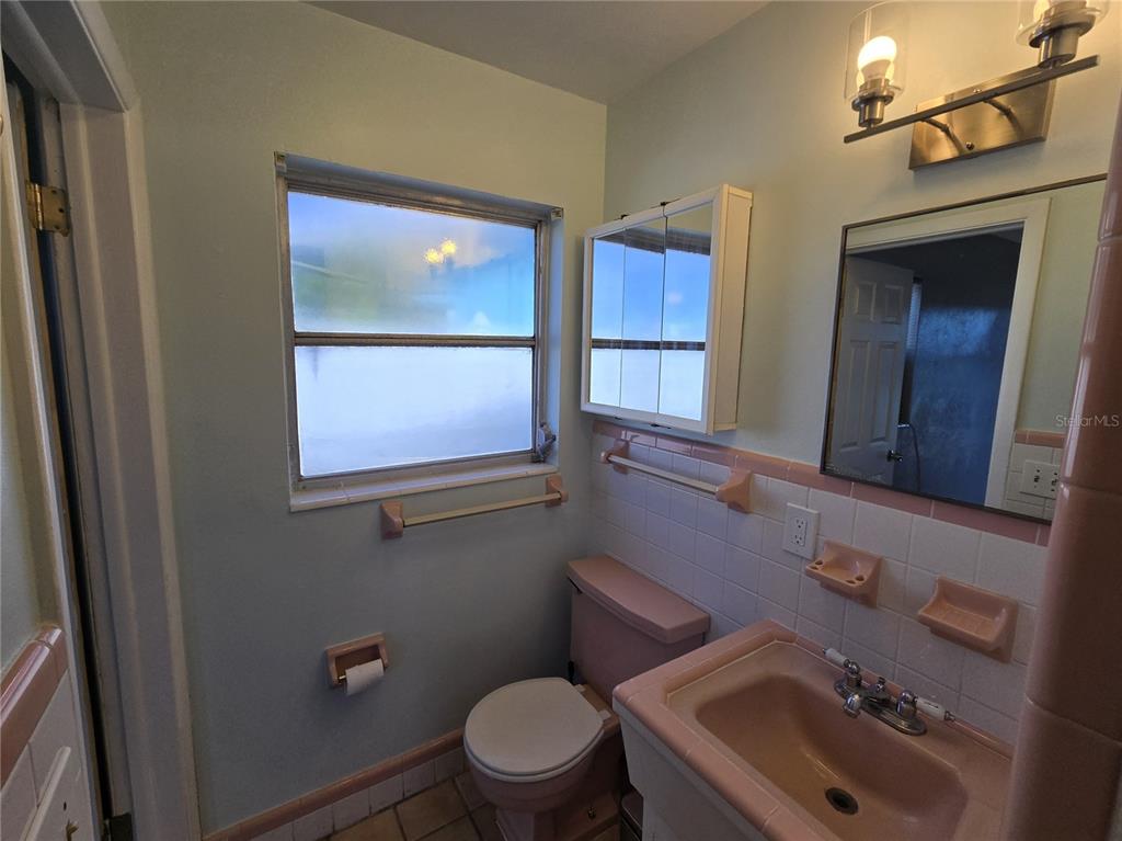 530 Lillian Drive Madeira Beach, FL 33708 - Photo 31 of 56 a bathroom with a sink and a mirror