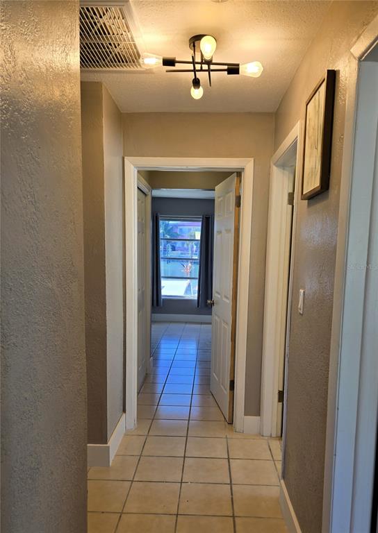 530 Lillian Drive Madeira Beach, FL 33708 - Photo 39 of 56 a view of a hallway with wooden floor and staircase