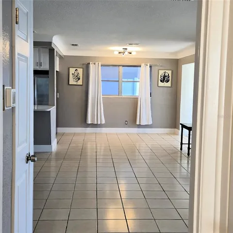 a view of a hallway with entryway and chandelier