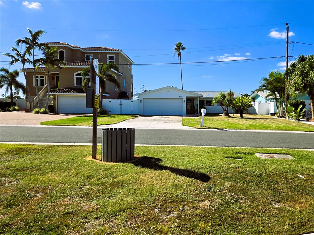 530 Lillian Drive Madeira Beach, FL 33708 - Photo 52 of 56 a front view of a house with a yard