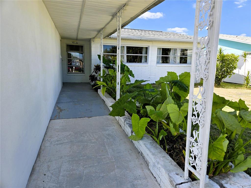 530 Lillian Drive Madeira Beach, FL 33708 - Photo 6 of 56 a front view of a house with garden