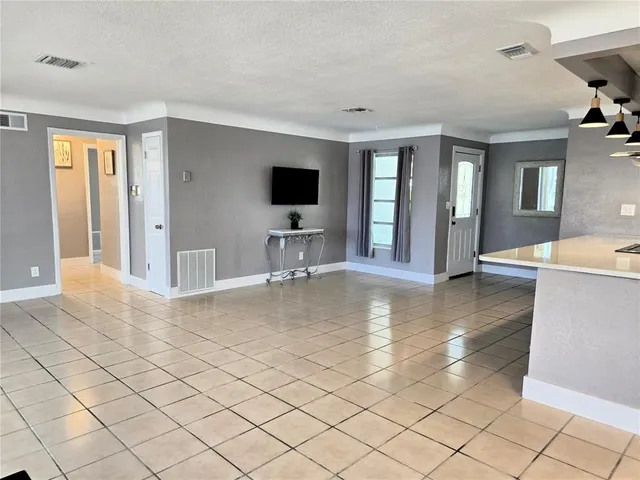 a view of a living room and kitchen