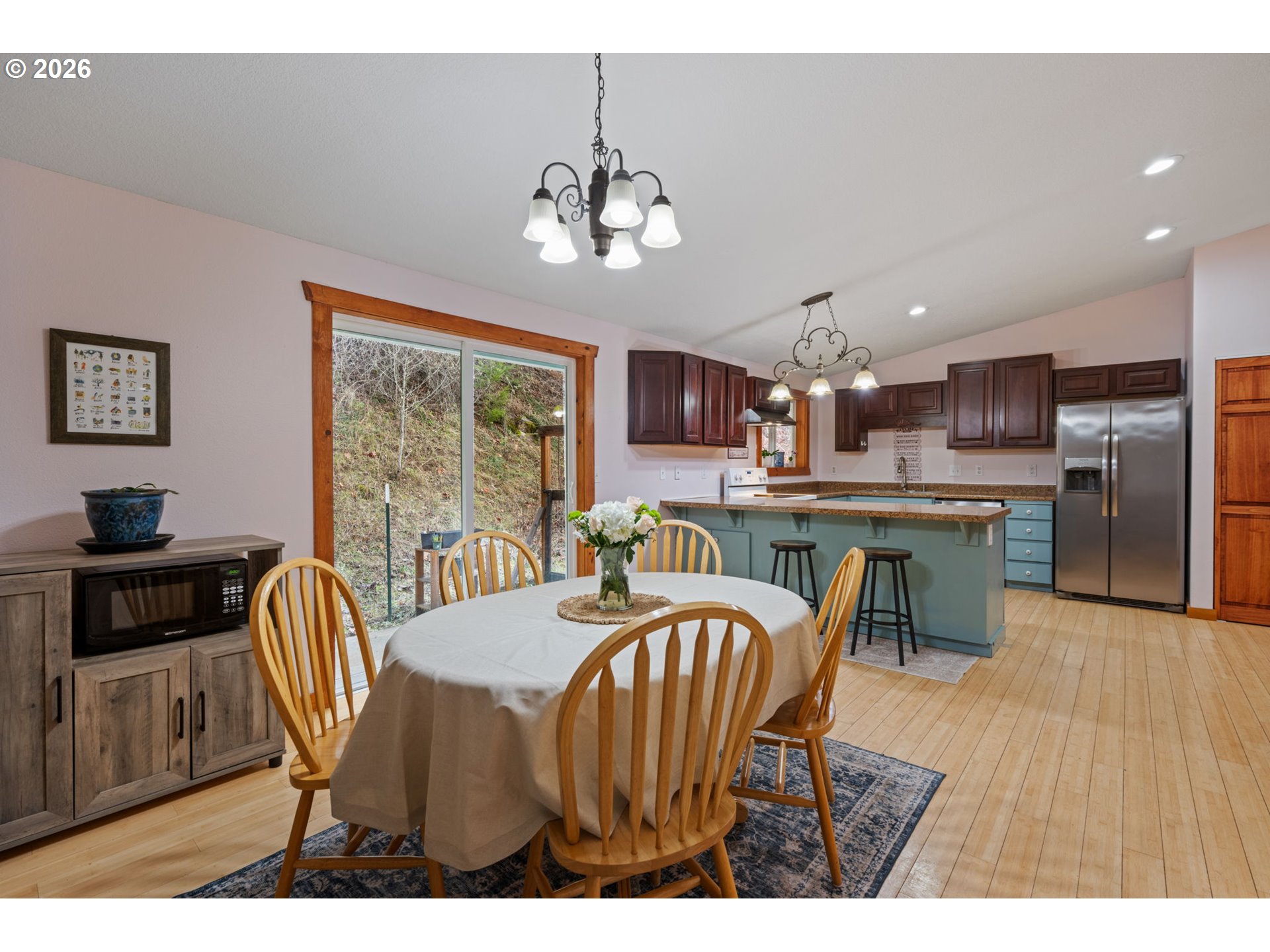 38220 Northeast Sunset Falls Road Yacolt, WA 98675 - Photo 11 of 40 a dining room with furniture a window and kitchen view