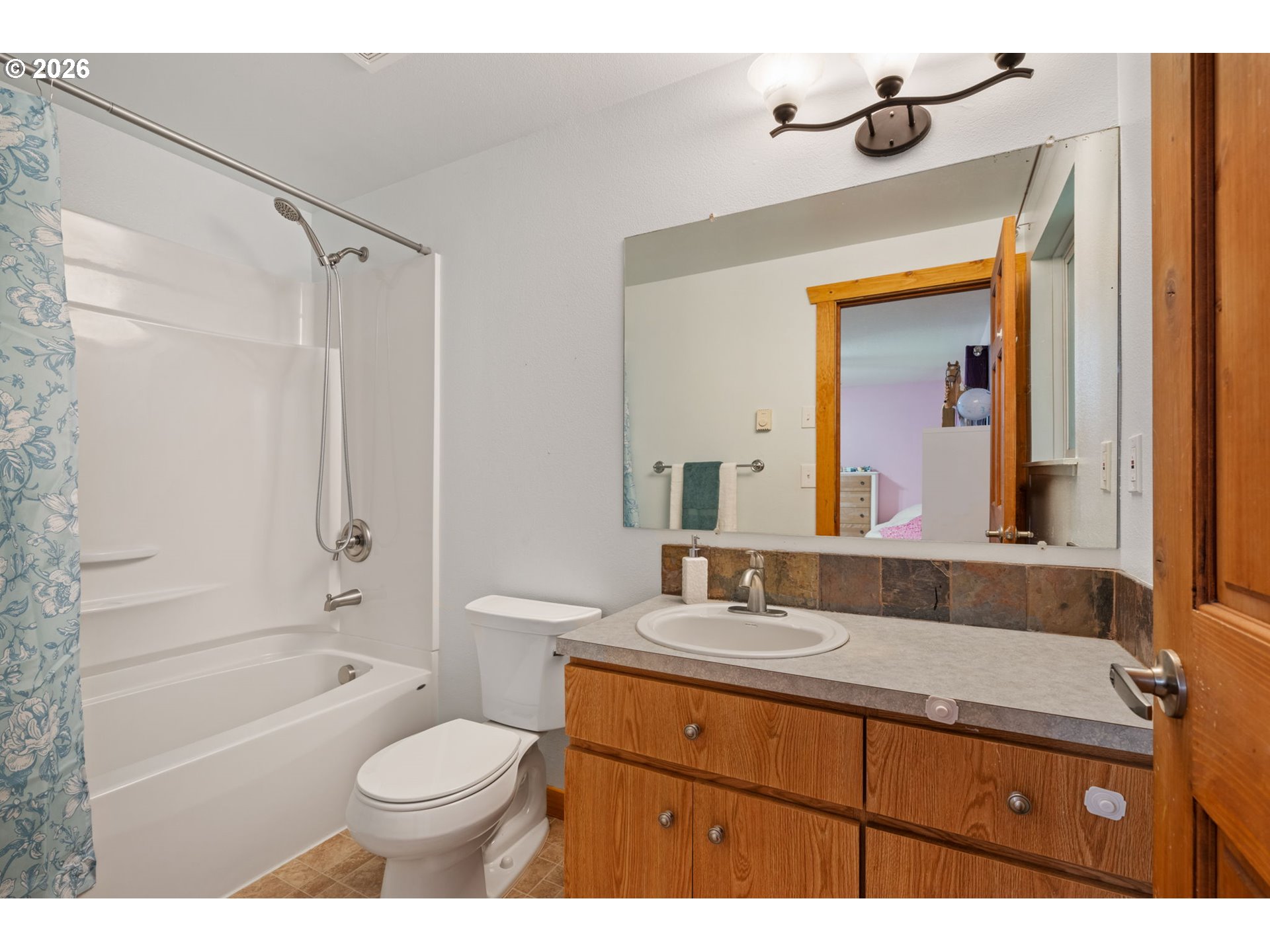 38220 Northeast Sunset Falls Road Yacolt, WA 98675 - Photo 20 of 40 a bathroom with a granite countertop sink toilet a shower and a bathtub